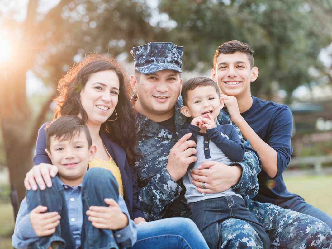Military family smiling together outdoors